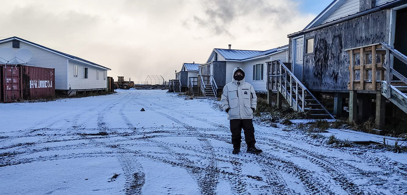 Cesar standing in the snow in Chevak, Alaska, during his first winter in the U.S.